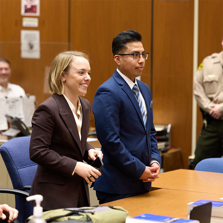 Two students dressed in professional attire in court