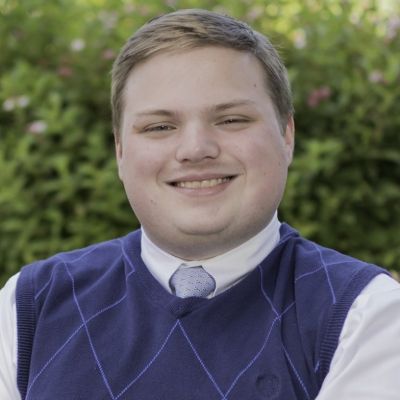 Headshot photo of Ben smiling at the camera