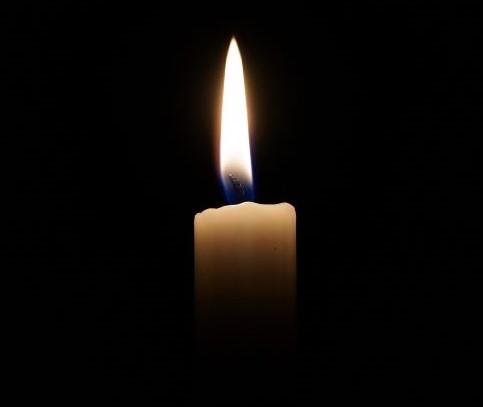 single candle in darkness